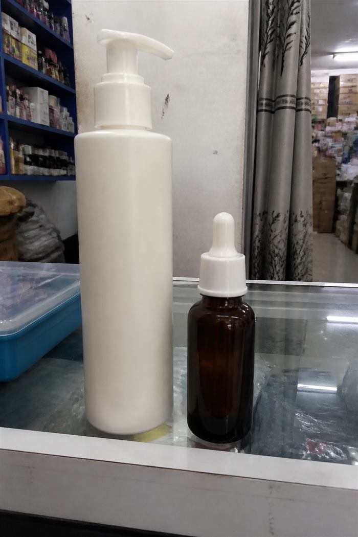 Original photo: two unlabelled skincare bottles on a shop counter