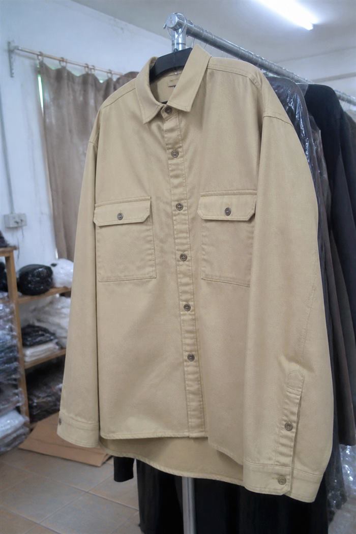 Original photo: beige overshirt on a hanger on a stockroom rail